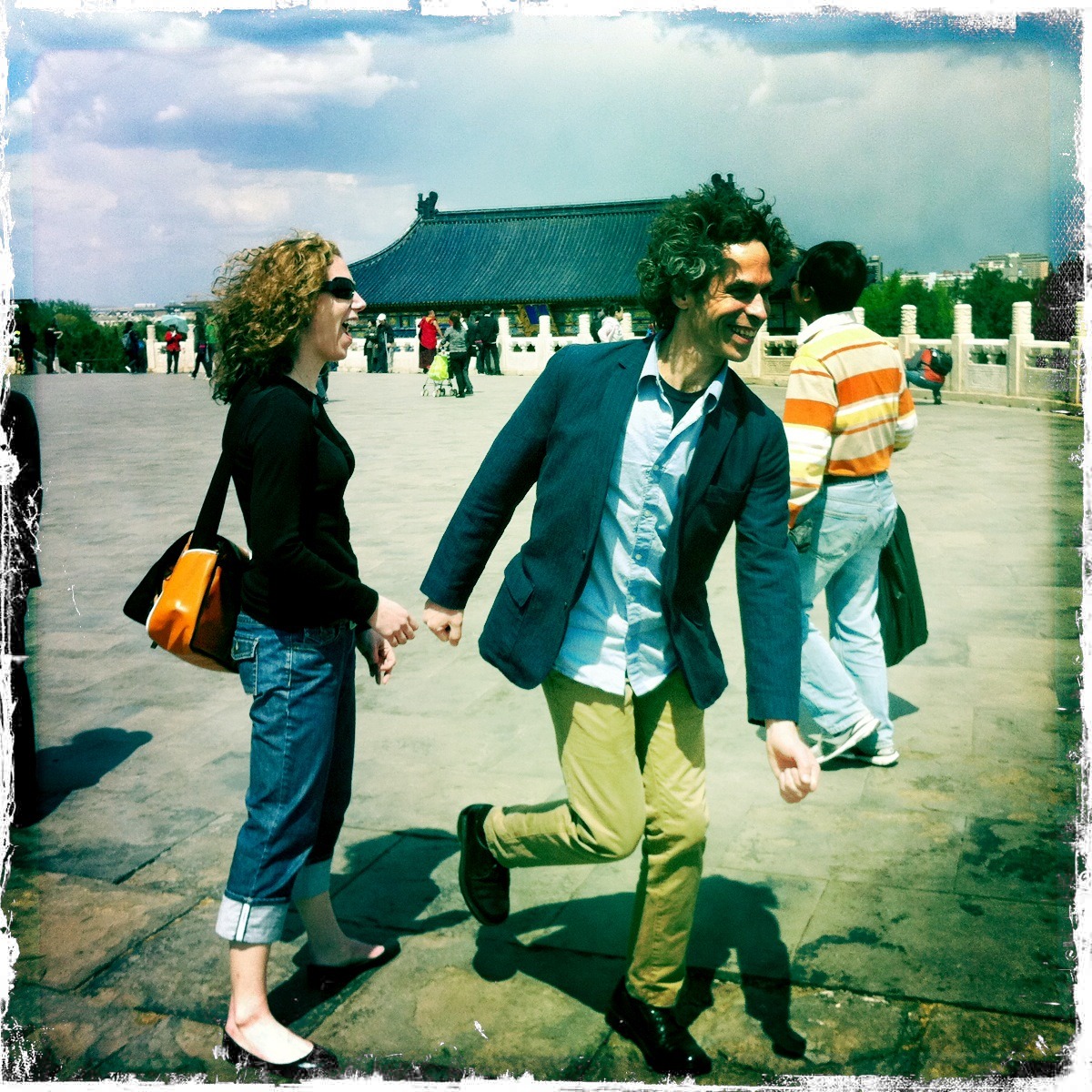 A man and woman holding hands while walking.